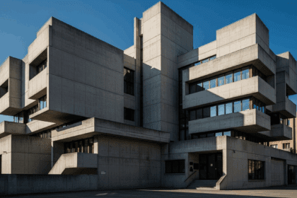 A striking, modernist concrete building with sharp angles and bold geometric shapes, set against a clear blue sky, showcasing the raw beauty of brutalist architecture, photorealistic, 4K, HDR, cinematic lighting, ultra detailed, award-winning photography, vibrant colors.