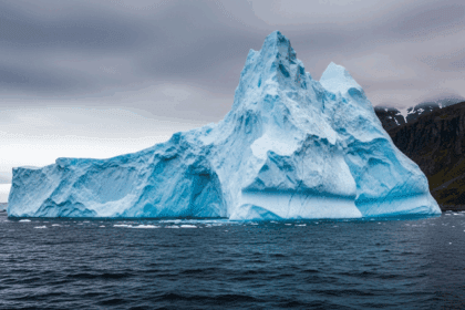 A colossal iceberg towering over the rugged coastline of South Georgia, with dramatic icy blue colors contrasting against the dark ocean under a moody sky. no texts on scene. Photography captures the grandeur of nature in photorealistic style, high resolution, 4k details, HDR, cinematic lighting, professional photography, studio lighting, vibrant colors.