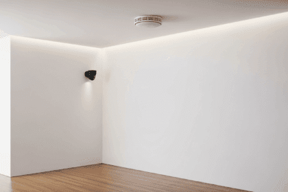 A modern home interior featuring the latest Nest Protect smoke detector elegantly mounted on the ceiling while a sleek security camera monitors the room, with a focus on advanced technology integration. No texts on scene. Photorealistic style, high resolution, 4k details, HDR, cinematic lighting, professional photography, studio lighting, vibrant colors.