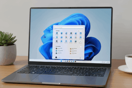 A close-up shot of a sleek laptop displaying the Windows 11 interface with vibrant icons and clear updates on the screen, set on a stylish desk with a plant and a coffee cup, photorealistic, 4K, HDR, cinematic lighting, ultra detailed, award-winning photography, studio shot, vibrant colors.