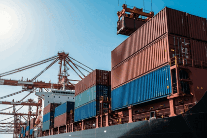 A close-up view of a bustling port with shipping containers being loaded onto a cargo ship, with cranes in the background and a clear blue sky overhead, photorealistic, 4K, HDR, cinematic lighting, ultra detailed, award-winning photography, studio shot, vibrant colors.